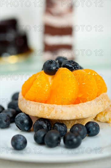 Fresh blueberry and tangerine orange cream cupcake homemade closeup macro