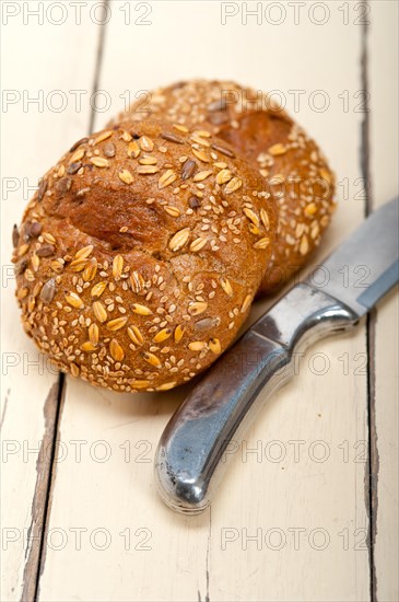 Fresh organic bread over rustic table macro closeup