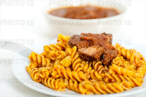 Fusilli pasta al dente with neapolitan style ragu meat sauce very different from bolognese style