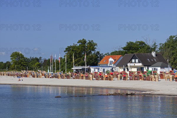 Roofed wicker beach chairs along the Baltic Sea at Kellenhusen