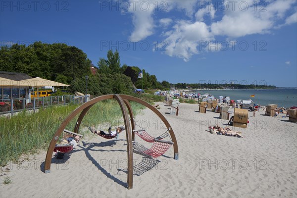 Sunbathers in hammocks and beach chairs at the seaside resort Haffkrug