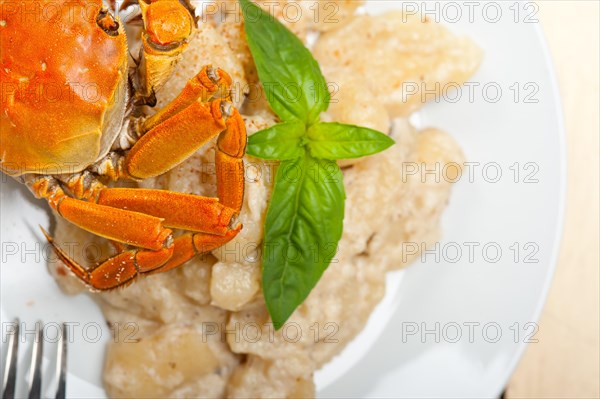 Fresh homemade Italian gnocchi with seafood sauce crab and basil