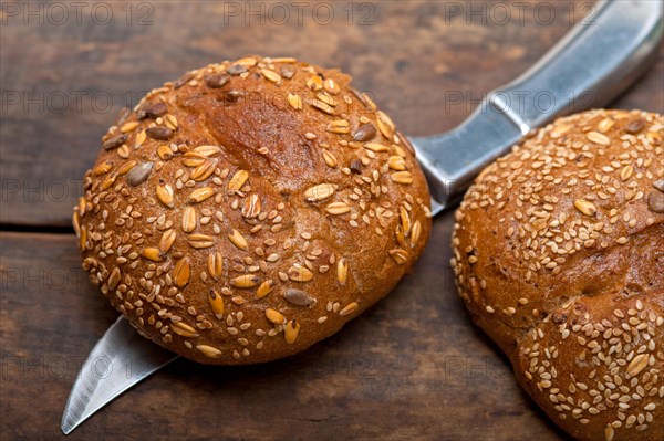 Fresh organic bread over rustic table macro closeup