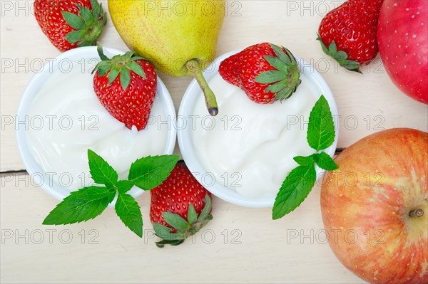 Fresh fruits and whole milk yogurt on a rustic wood table