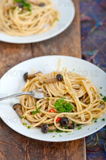 Italian pasta and mushroom sauce over rustic old wood