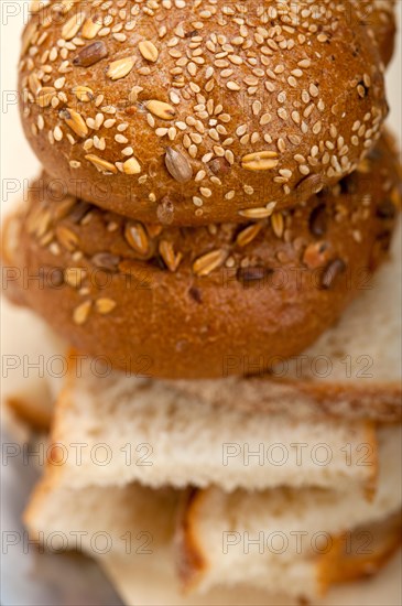 Fresh organic bread over rustic table macro closeup