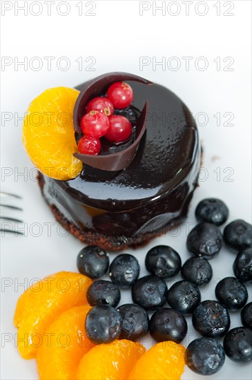 Chocolate cake and fresh fruit on top closeup macro