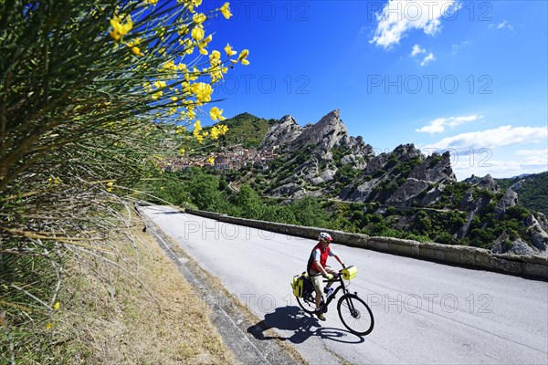 Cyclist with panniers on the road outside Castelmezzano