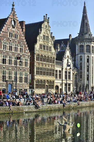 People enjoying the first spring sun by the waterside along the Graslei at Ghent