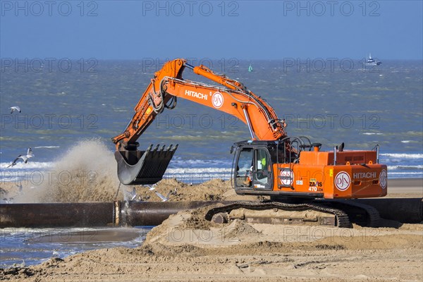 Hydraulic excavator connecting pipes of pipeline during sand replenishment