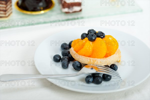 Fresh blueberry and tangerine orange cream cupcake homemade closeup macro