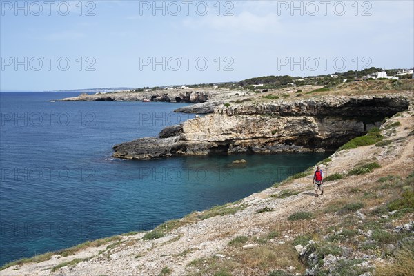 Hikers on the rocky coast of San Marina de Leuca