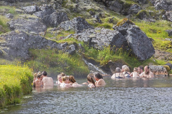 Tourists bathing in hot spring at Landmannalaugar valley