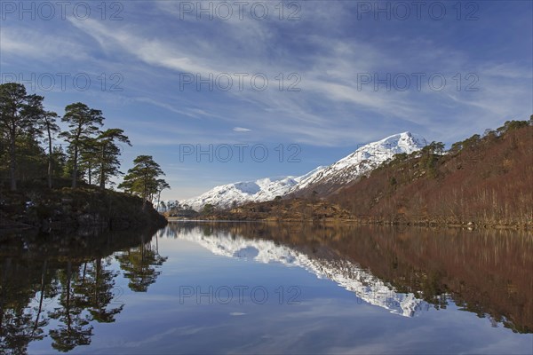 Caledonian Forest along Loch Affric and mountain Sgurr na Lapaich in winter