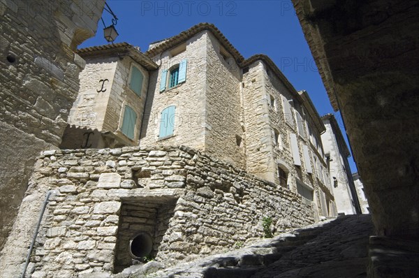 Steep alley with medieval houses in the village Gordes