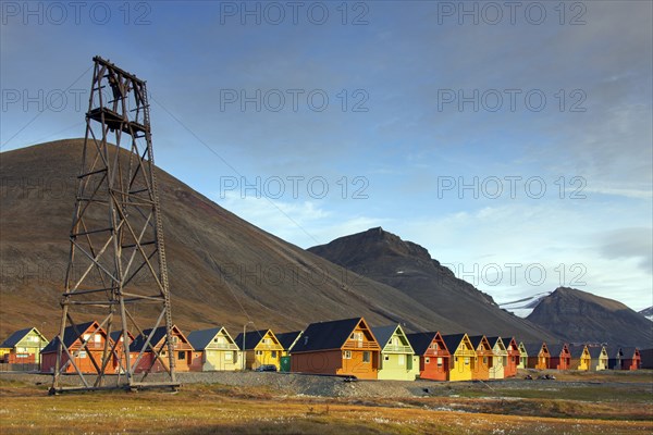 Cableway from abandoned coal mine and colourful wooden houses in the settlement Longyearbyen in summer