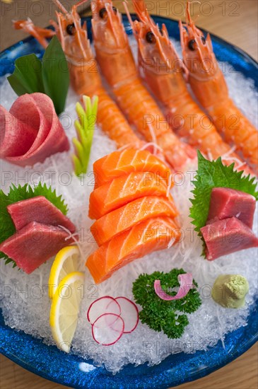 Japanese style assorted sashimi dish laid over crushed ice