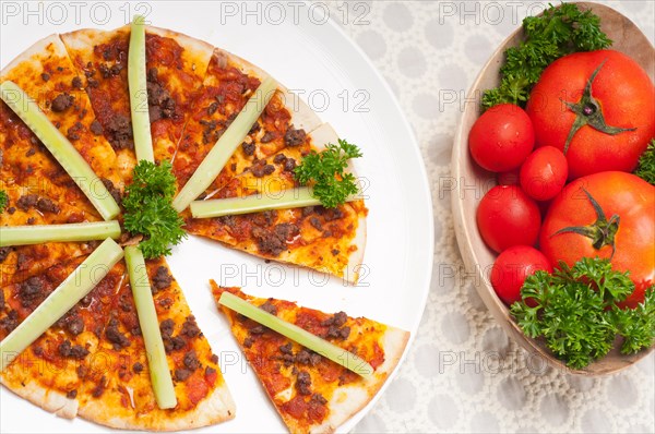 Fresh baked Turkish beef pizza with cucumber on top