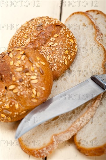 Fresh organic bread over rustic table macro closeup