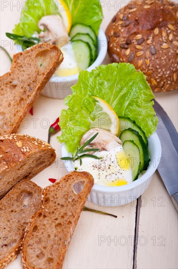 Fresh organic garlic cheese dip salad on a rustic table with bread