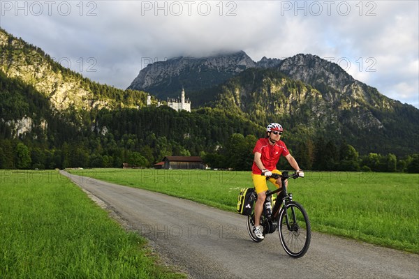 Cyclist in front of Neuschwanstein Castle