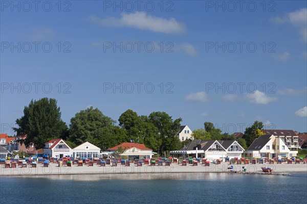 Roofed wicker beach chairs along the Baltic Sea at Kellenhusen