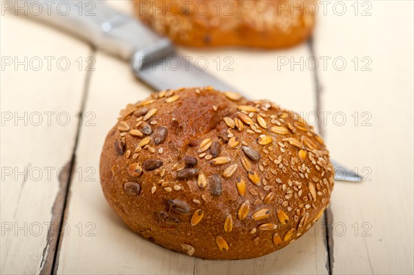 Fresh organic bread over rustic table macro closeup