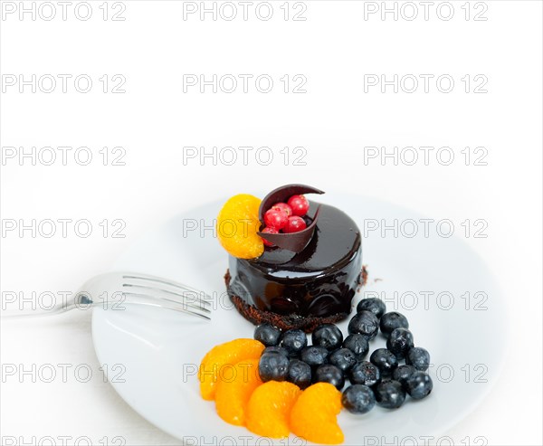 Chocolate cake and fresh fruit on top closeup macro