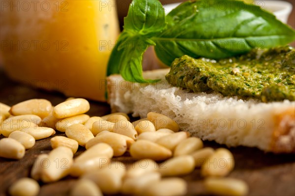 Italian basil pesto bruschetta ingredients over old wood macro