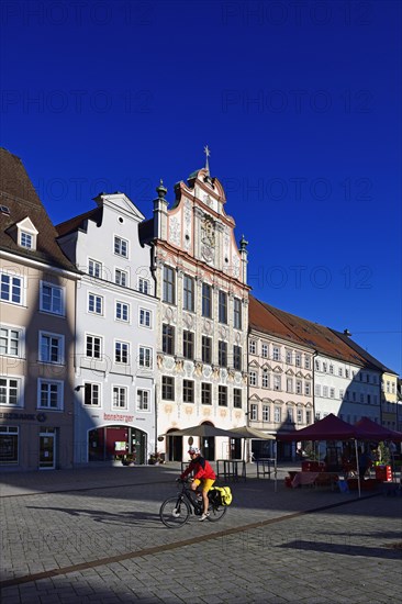 Cyclist in front of the market in the old town centre