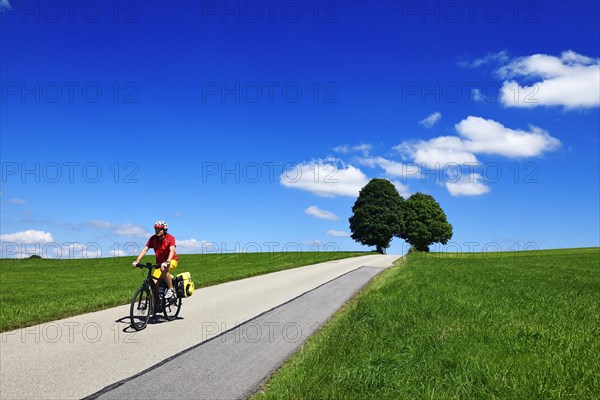 Cyclist on a picture-book country road near Berg