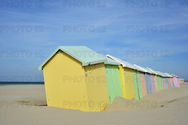 Row of colourful beach cabins in pastel colours along the North Sea at Berck