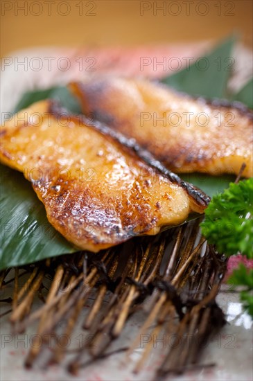 Japanese style teppanyaki roasted cod fish on palm leaf