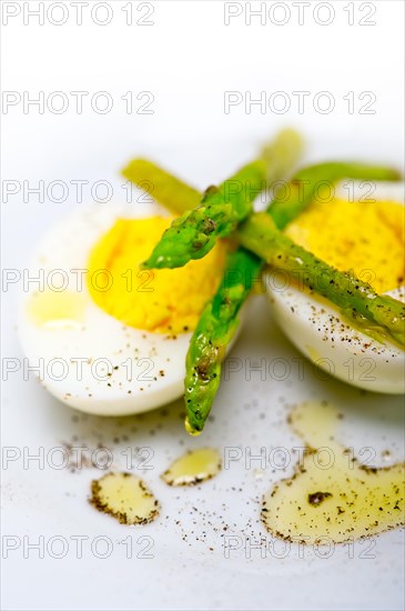 Boiled fresh green asparagus and eggs with extra virgin olive oil