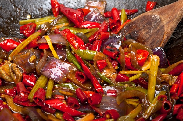 Fried chili pepper and vegetable on a iron wok pan