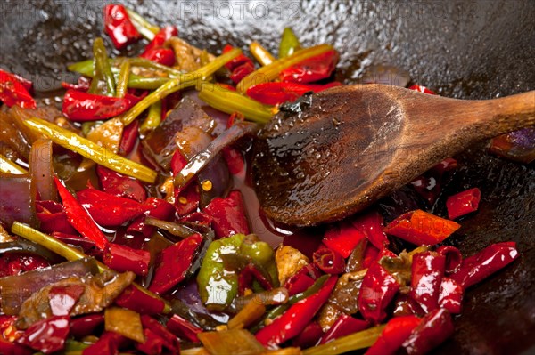 Fried chili pepper and vegetable on a iron wok pan