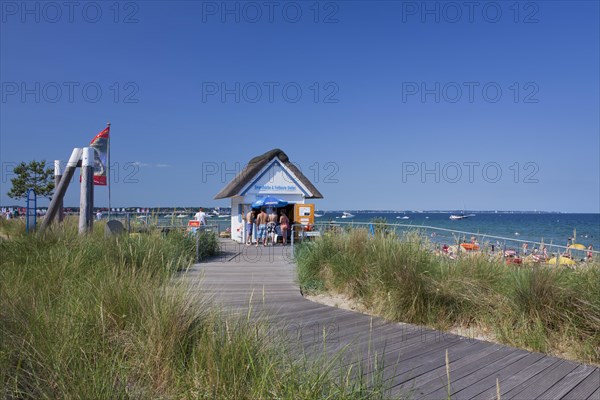 Cabin renting out roofed wicker beach chairs along the Baltic Sea at Scharbeutz