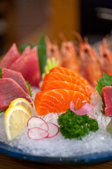 Japanese style assorted sashimi dish laid over crushed ice