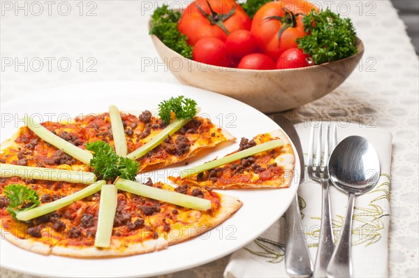 Fresh baked Turkish beef pizza with cucumber on top