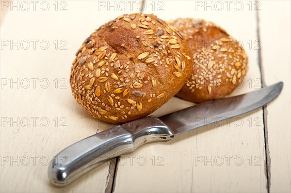 Fresh organic bread over rustic table macro closeup