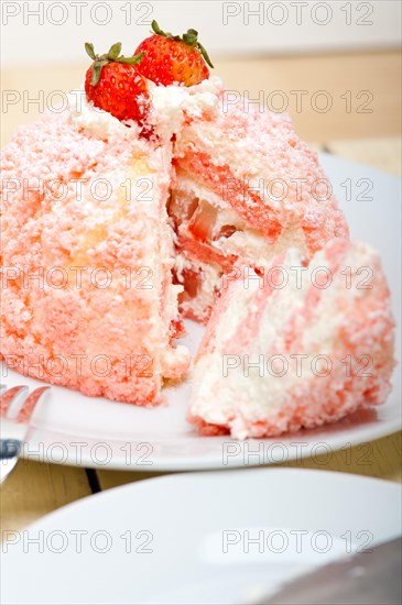 Fresh pink strawberry and whipped cream dessert macro close up