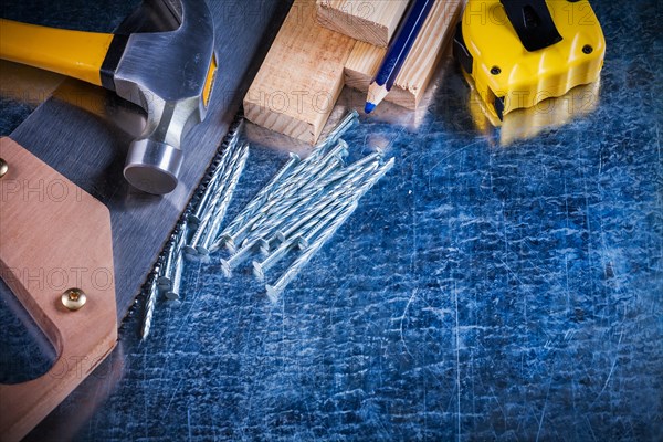 Building nails Hammer Wooden tile Hand saw Pencil and adhesive tape Line on scratched metallic surface Maintenance concept