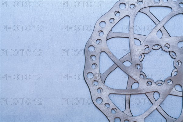 Metal gear wheel on flat metallic background Machine concept