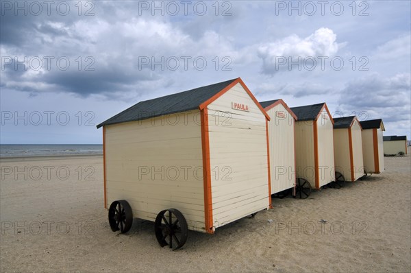 Row of colourful beach cabins on wheels along the North Sea coast at De Panne