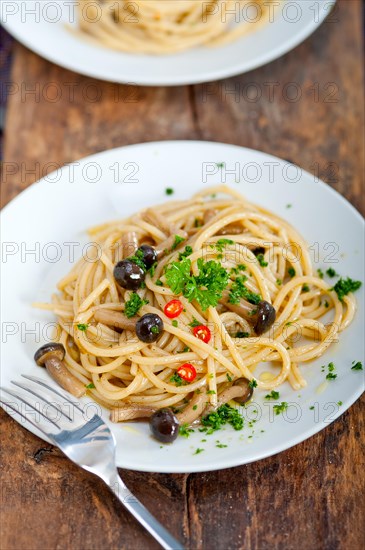 Italian pasta and mushroom sauce over rustic old wood