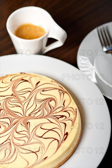 Fresh baked classic Cheese cake with chocolate topping and espresso coffee