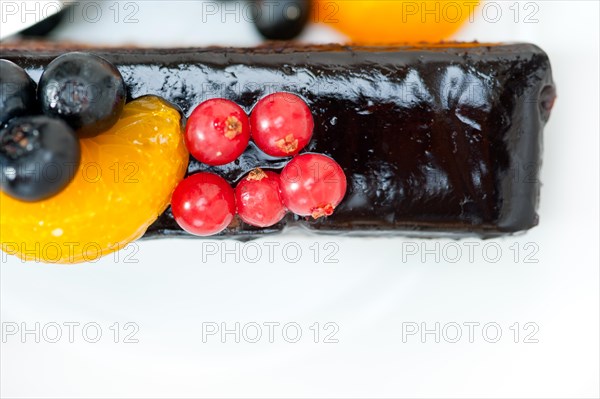 Chocolate cake and fresh fruit on top closeup macro