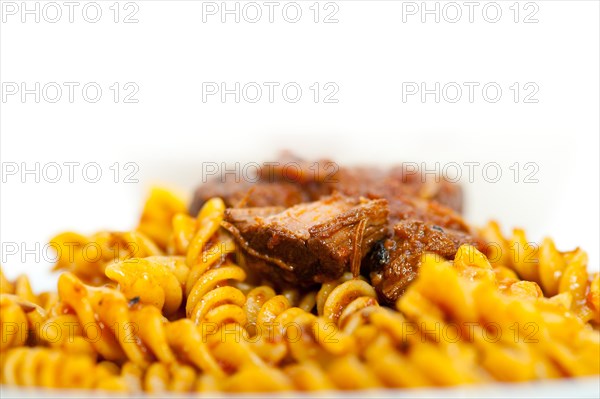 Fusilli pasta al dente with neapolitan style ragu meat sauce very different from bolognese style