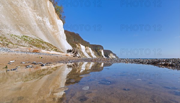 Eroded white chalk cliffs and pebble beach in Jasmund National Park on Rugen Island in the Baltic Sea