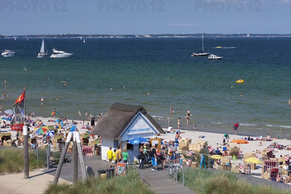 Cabin renting out roofed wicker beach chairs along the Baltic Sea at Scharbeutz